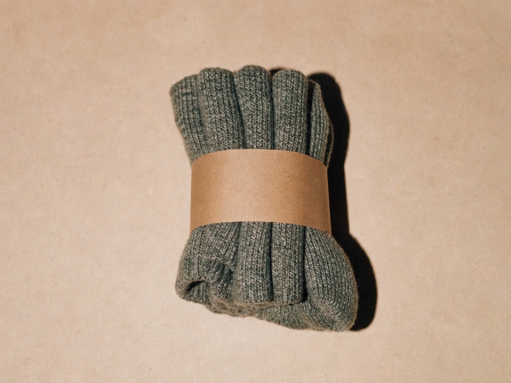 Three rolled grey-green wool trail socks