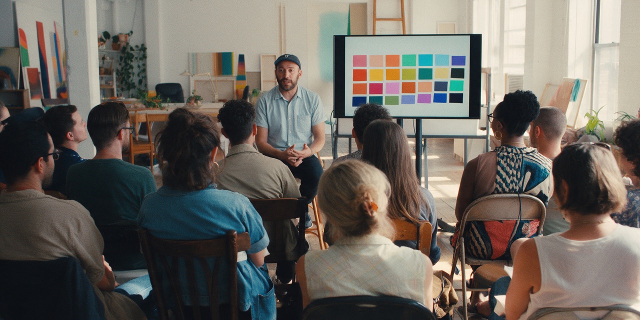 People watching a speaker at a design meetup